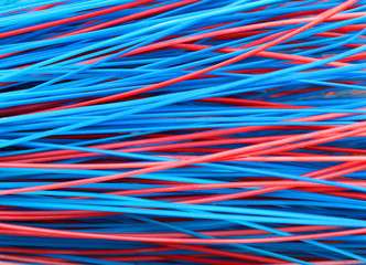 Colorful red and blue stems of plastic broom closeup