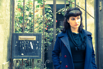 Retro girl in front of a old house.