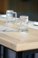 empty glass mug, cutlery and white dish