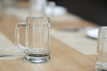 empty glass mug, cutlery and white dish