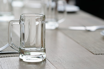 empty glass mug, cutlery and white dish