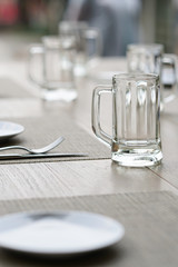 empty glass mug, cutlery and white dish