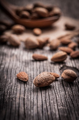 Tasty almond nuts on rustic wooden background