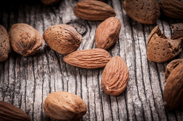 Tasty almond nuts on rustic wooden background