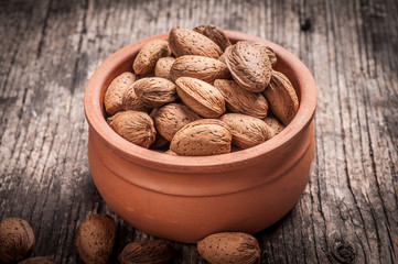 Tasty almond nuts on rustic wooden background