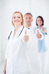 team of doctors showing thumbs up