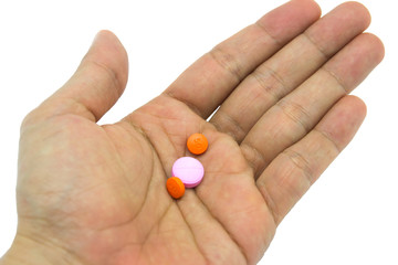 Hand holding pills on white background