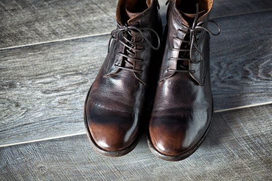 new leather men's shoes on wooden background