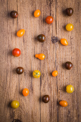 Fototapeta na wymiar Cherry tomatoes on a wooden background