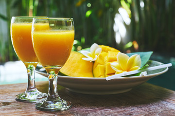 Glasses of fresh tropical smoothie or mango juice