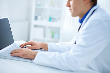 Male doctor using notebook