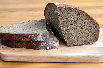 Black bread slices on the cutting board