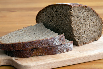 Black bread slices on the cutting board