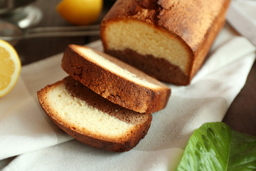 Delicious sweet cake bread with lemons on napkin closeup