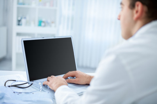 Doctor in the office using a computer