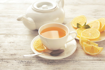 Cup of tea with ginger on a light wooden background
