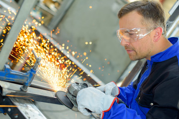 man polishing a steel frame