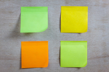 colorful sticky note on wood background.