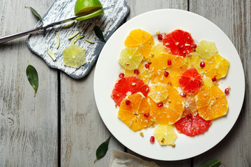 Cutting citruses on plate