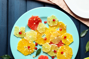 Cutting citruses on plate