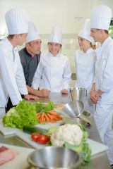 Chef talking to team of trainees