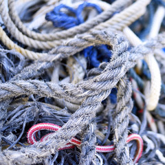 Weathered, old nautical ropes. Stack of ropes, close-up of nautical vessel. 