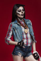 Beautiful sexy brunette model woman.Look zombie. Creative make up. Helloween concept. On red background