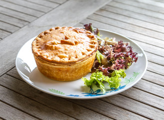 Meat pie with salad on the side