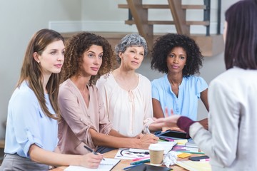 Woman giving presentation to her colleagues 