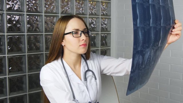 young and nice doctor watching a patient x-ray in hospital
