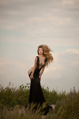young blond woman in elegant black dress 