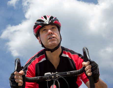 portrait of cyclist at sky background