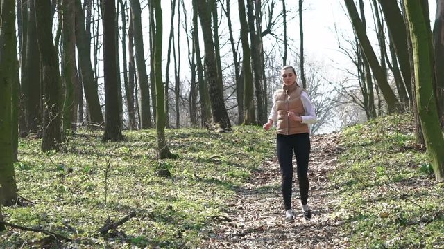 Sexy girl running in the woods. Slow motiom