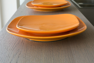 Orange empty dishes on a wooden floor