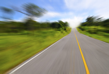 Country road with motion blur under blue sky