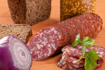 Salami for Breakfast with pepper on a wooden table