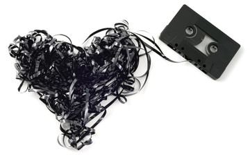 vintage audio cassette with tangled messy tape in heart shape fo