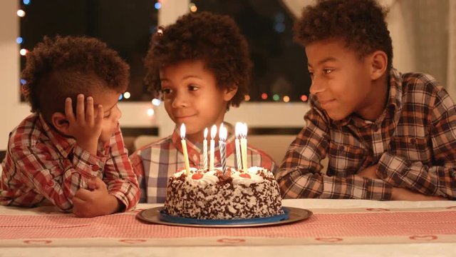 Afro boys and birthday cake.