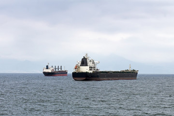 Obraz premium Cargo ships anchored at the harbor.