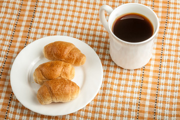 small croissants and cup of coffee