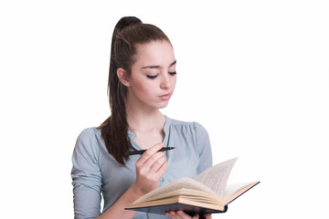 Young beautiful girl reading a book and thinking