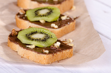 Toast with chocolate, kiwi fruit and nuts