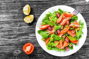 Red fish healty salad on white dish