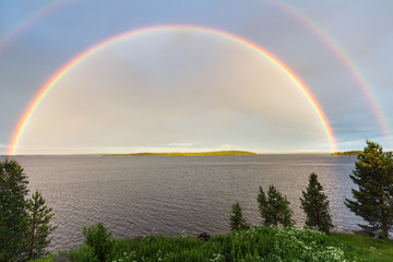 Naklejka premium Double colorful rainbow over the lake