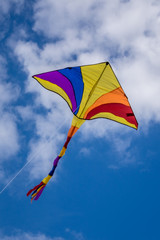 Colourful kite flying high in the sky on a kite day