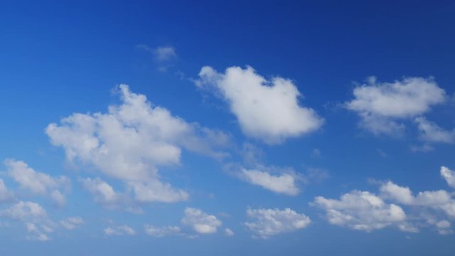 UHD real time shot of clouds running in a deep blue sky