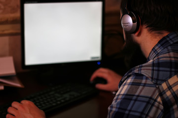 Fototapeta na wymiar man play computer with headphones