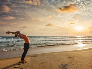 Fototapeta na wymiar Woman doing yoga Sun salutation Surya Namaskar 
