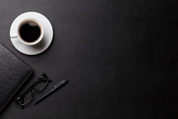 Office desk with coffee, notepad and pen