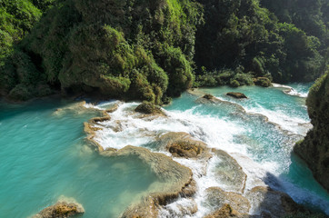 Downstream of a river with turquoise water between rocky shores